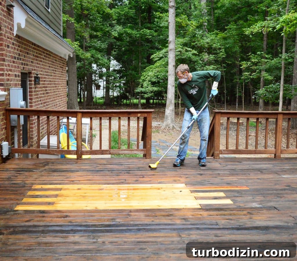 John scrubbing wood deck with deck brightener cleaner