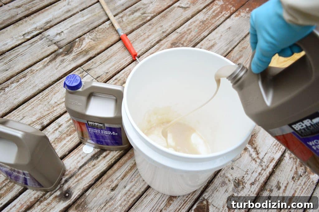 Pouring deck stripper into a bucket