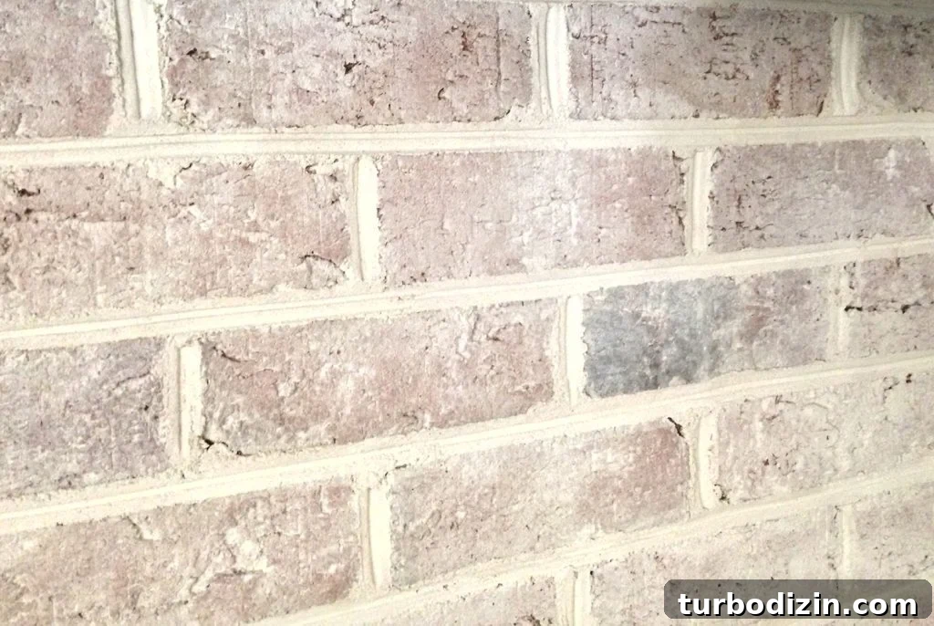 Whitewashing a Brick Fireplace: Step-by-Step Guide for a Fresh Look 12 close up detail of brick wall fireplace with a DIY whitewash treatment applied
