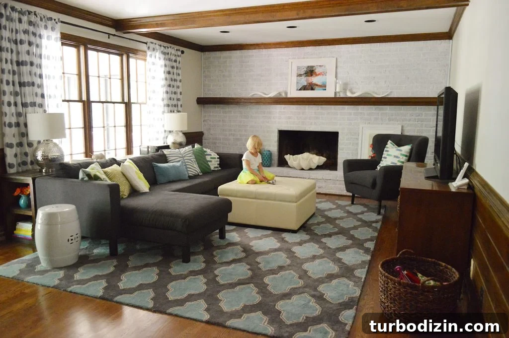 Whitewashing a Brick Fireplace: Step-by-Step Guide for a Fresh Look 13 stylish and colorful living room with navy blue furniture, graphic pillows and rug, wood beams, and whitewash brick fireplace wall