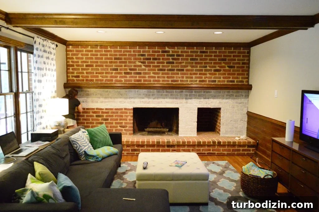 Whitewashing a Brick Fireplace: Step-by-Step Guide for a Fresh Look 7 whitewash brick technique being applied to living room fireplace wall made of brick