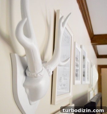 How to Arrange a Gallery Wall Around Your TV for Impact 11 Faux taxidermy and pin map