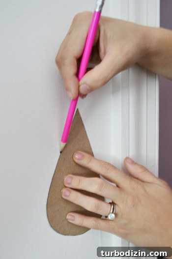 Painting a Pink Closet Door and Raindrop Wall Accent Ideas 11 Tracing Raindrops On Wall With Pencil using Cardboard Template Shape