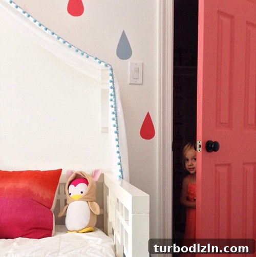 Painting a Pink Closet Door and Raindrop Wall Accent Ideas 5 Girl Peeking Out Of Colorful Pink Closet Door Next To Raindrop Mural Bed | Cinco de Mayo