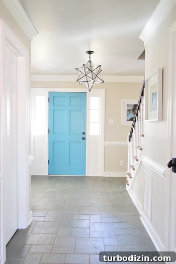 Foyer with blue door and gray ceiling Revere Pewter Benjamin Moore and greige walls Edgecomb Gray