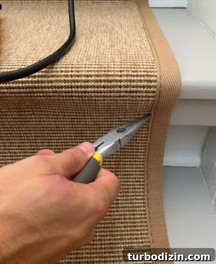 Needlenose Pliers Removing Staple On Sisal Stair Runner