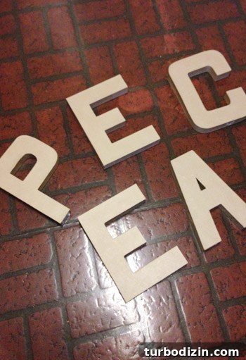 4 DIY Holiday Crafts to Transform Your Home This Season 14 Cardboard craft letters from JoAnn Fabric spelling PEACE
