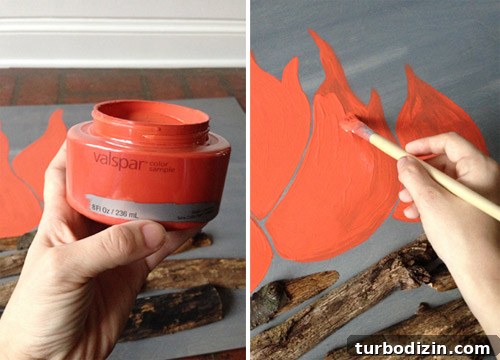 4 DIY Holiday Crafts to Transform Your Home This Season 7 Sherry painting fake flames on DIY faux holiday fireplace