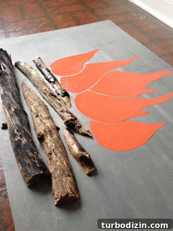 4 DIY Holiday Crafts to Transform Your Home This Season 8 Finished faux flames painted atop cut tree branches on faux holiday DIY fireplace