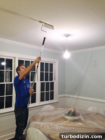John painting ceiling with roller