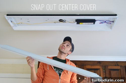 John uninstalling metal cover in boxy fluorescent light