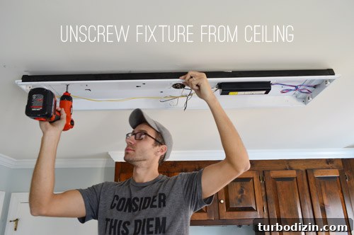 John uninstalling kitchen fluorescent light with screwdriver