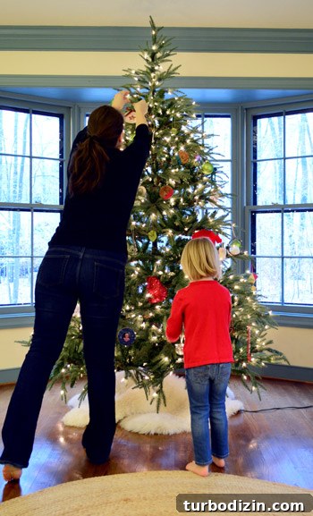 child-hanging-ornaments