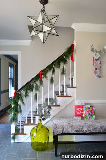 Festive Holiday Decorating Ideas for a Cozy Home 2 Stair garland and bench in foyer