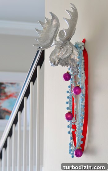 Festive Holiday Decorating Ideas for a Cozy Home 3 Silver moose on wall with ribbon and ornaments