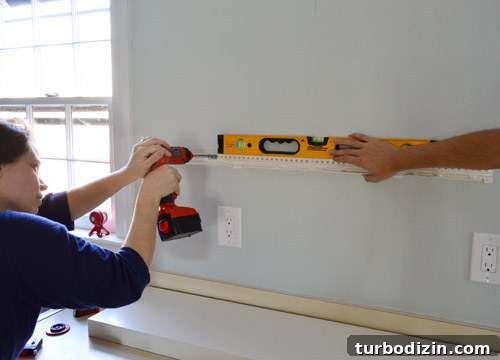 How We Installed Ikea Floating Shelves in Our Kitchen 11 making sure Ikea floating shelf hanging bracket is level while screwing it to the wall