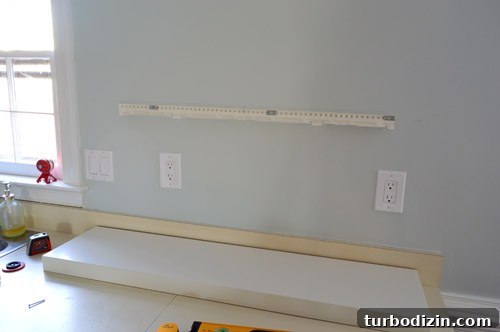 How We Installed Ikea Floating Shelves in Our Kitchen 12 metal bracket screwed to kitchen wall before placement of floating shelf