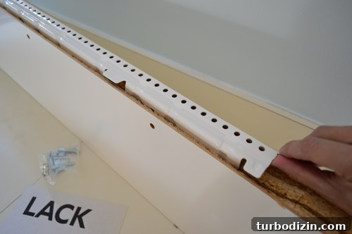 How We Installed Ikea Floating Shelves in Our Kitchen 9 close-up detail of white metal hanging bracket for LACK Ikea floating shelf