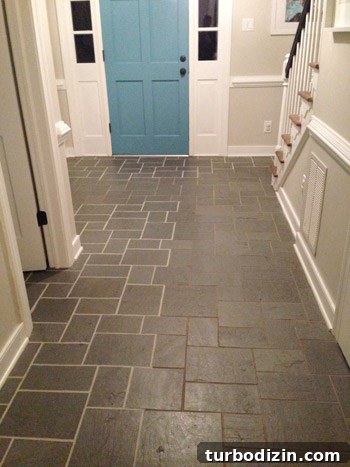 How We Restored Stained Grout to Bright White Again 12 side by side comparison of clean bright grout and dirty discolored grout from using grout paint in foyer
