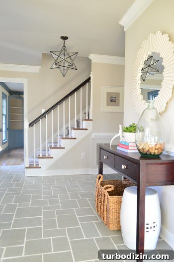 How We Restored Stained Grout to Bright White Again 6 foyer entryway with gray slate tile floor and clean white grout lines including pretty mirror and star pendant light