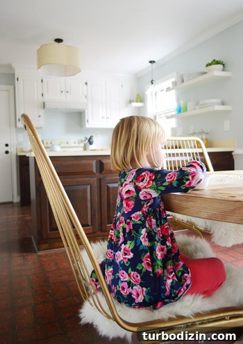 Child sitting on wire chair