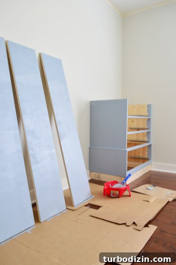 Primed wood pieces of Ikea Fjell waiting to dry