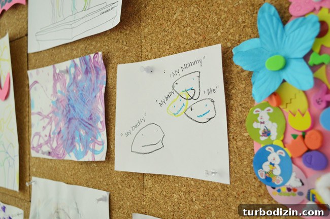 Create a Cork Wall Gallery for Kids’ Artwork 15 kids drawing of mommy daddy me and baby pinned to giant cork board wall