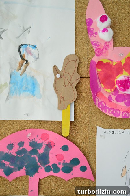 Create a Cork Wall Gallery for Kids’ Artwork 16 detail of kid art project with drawn bear on a popsicle stick