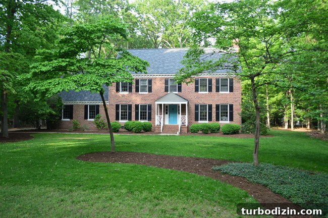 Create Mulch Planting Beds: Step-by-Step Guide for Lush Gardens 14 Front View Of Brick Colonial Home This Summer With Green Grass and Mulch Beds
