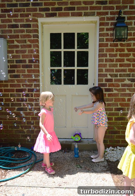 How to Paint a Garage Door and Outdoor Utility Box 2 Girls Playing With Bubbles At Kids Birthday Party In Front Of Brick Wall And Unpainted Garage Door