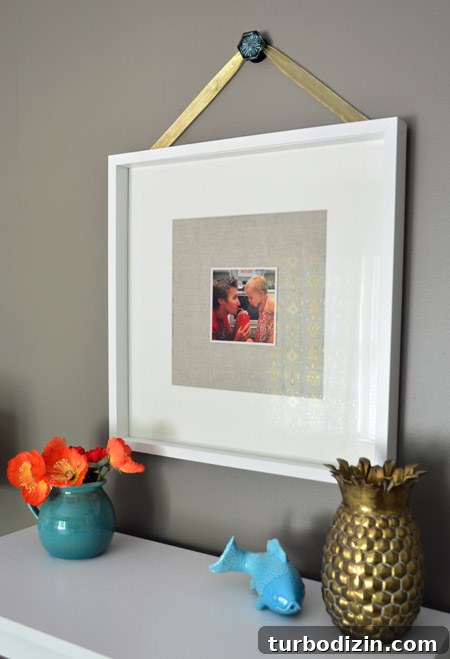 Our Top Pick for a Cozy Bedroom Paint Color 8 Art hanging in bedroom with BM Sparrow walls