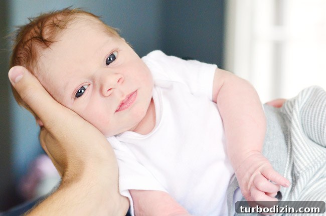 Newborn Photography: A Simple Guide to Shooting Your Baby at Home 11 DIY Newborn Photo Shoot Portrait With Eyes Open