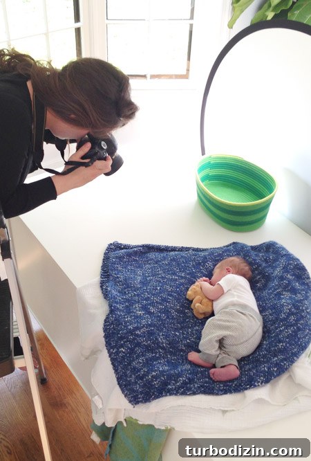 Newborn Photography: A Simple Guide to Shooting Your Baby at Home 7 Sherry Taking Photo Of Infant Son On Blue Homemade Blanket With Teddy Bear