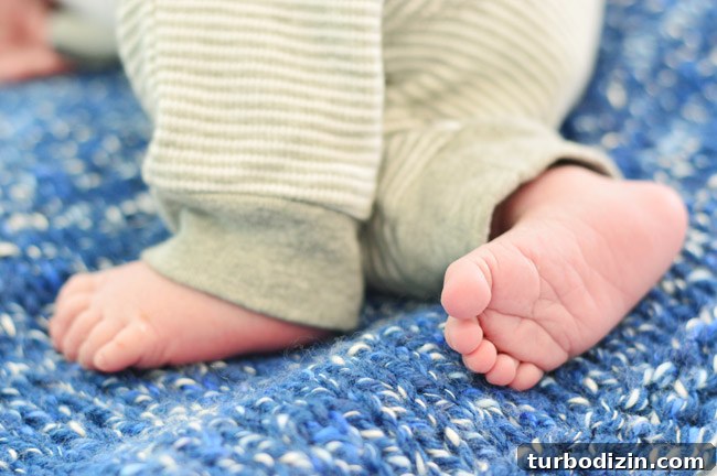 Newborn Photography: A Simple Guide to Shooting Your Baby at Home 9 DIY Newborn Photo Of Infant Feet On Blue Blanket For Birth Announcement