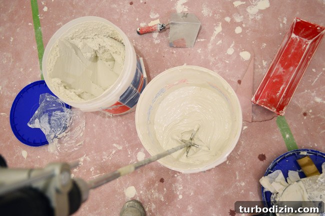 Drywall Taping, Mudding, and Sanding: Step-by-Step Guide 36 mixing bucket of drywall mud joint compound with drill mixing paddle