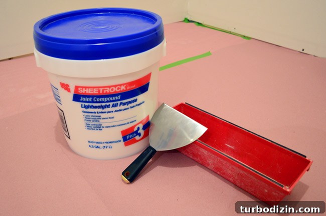 Drywall Taping, Mudding, and Sanding: Step-by-Step Guide 5 drywall mud or sheetrock join compound with spackle knife and mud pan