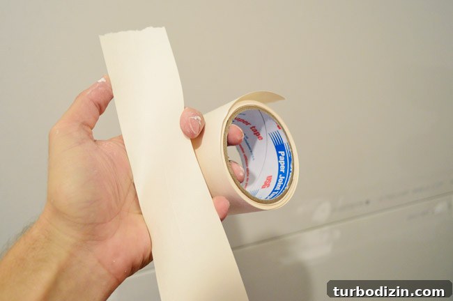 Drywall Taping, Mudding, and Sanding: Step-by-Step Guide 9 drywall tape shown torn and ready to apply