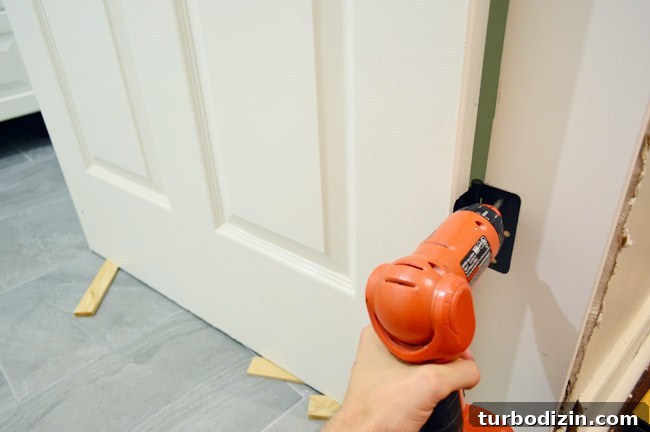 How to Hang a Door: Step-by-Step Guide for a Perfect Fit 18 Hanging Door In DIY Jamb Using Screwdriver To Attach Door Hinges
