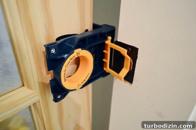 How to Hang a Door: Step-by-Step Guide for a Perfect Fit 29 Ryobi Door Lockset Kit Clamped To Unfinished Door To Mark Location Of Knob And Strikeplate