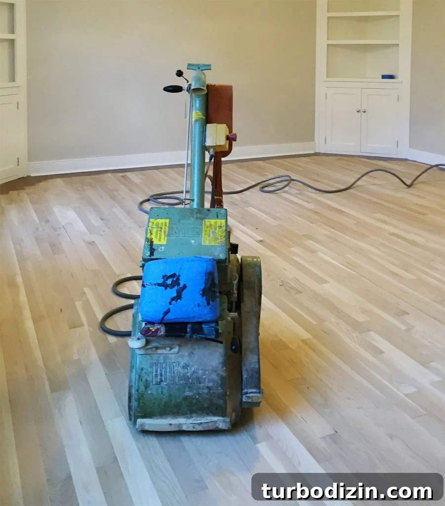 How to Refinish Hardwood Floors: Step-by-Step Guide 2 Professional floor sander on bare sanded oak floors