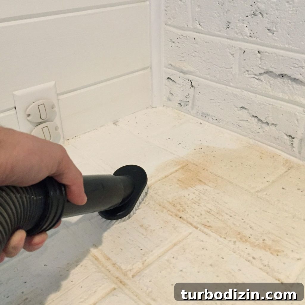How to Refinish Hardwood Floors: Step-by-Step Guide 14 Vacuuming up sanding dust from hardwood floor refinishing project