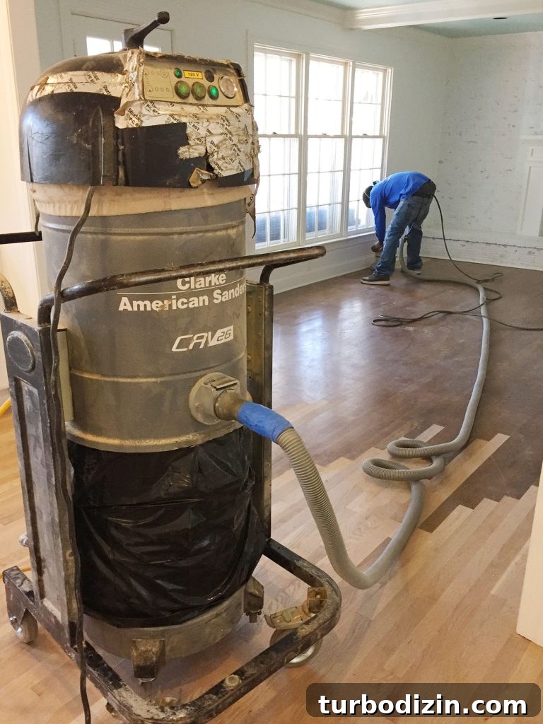 How to Refinish Hardwood Floors: Step-by-Step Guide 3 Man Sanding Hardwood Floors Using Industrial Sander