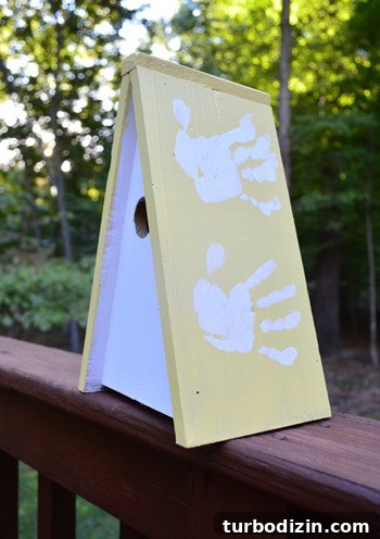 Handprints on the birdhouse roof