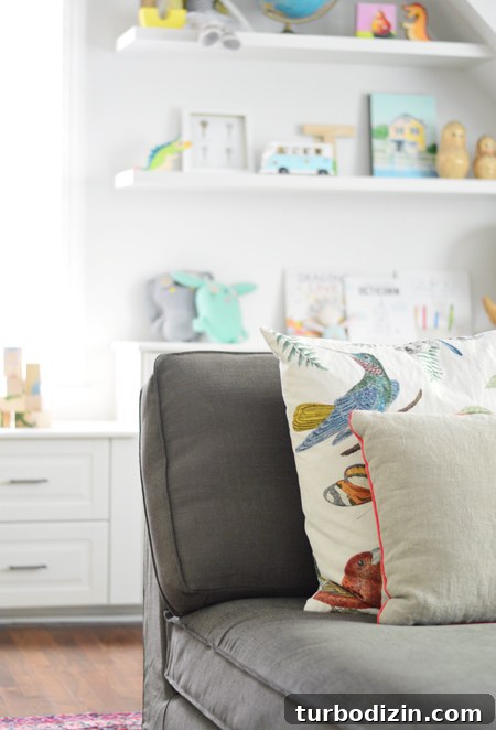 How We Transformed Our Bonus Room Into a Stylish Lounge 14 Playful-Family-Bonus-Room-Kivik-Gray-Brown-Bird-Pillow