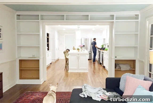 How to Build Custom Built-In Bookshelves for Your Home 17 DIY bookshelves mid construction with face pieces on unfinished edges
