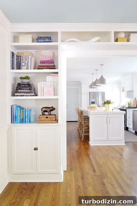 How to Build Custom Built-In Bookshelves for Your Home 19 built-in bookshelves in opening to kitchen