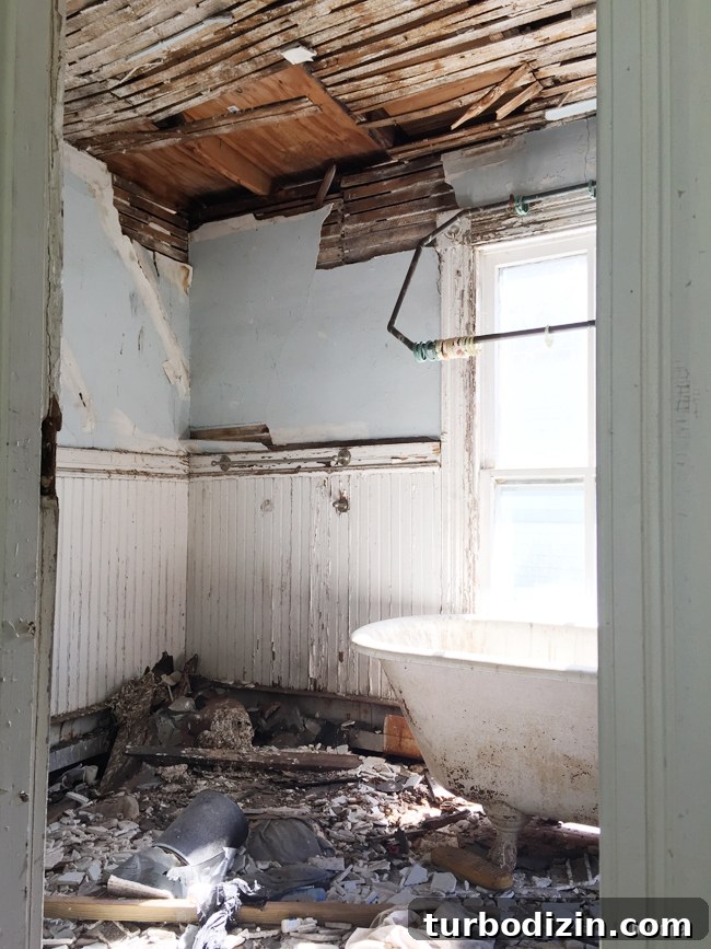 Beach House Renovation: Stripping to the Studs Guide 13 Damaged bathroom behind enclosed porch