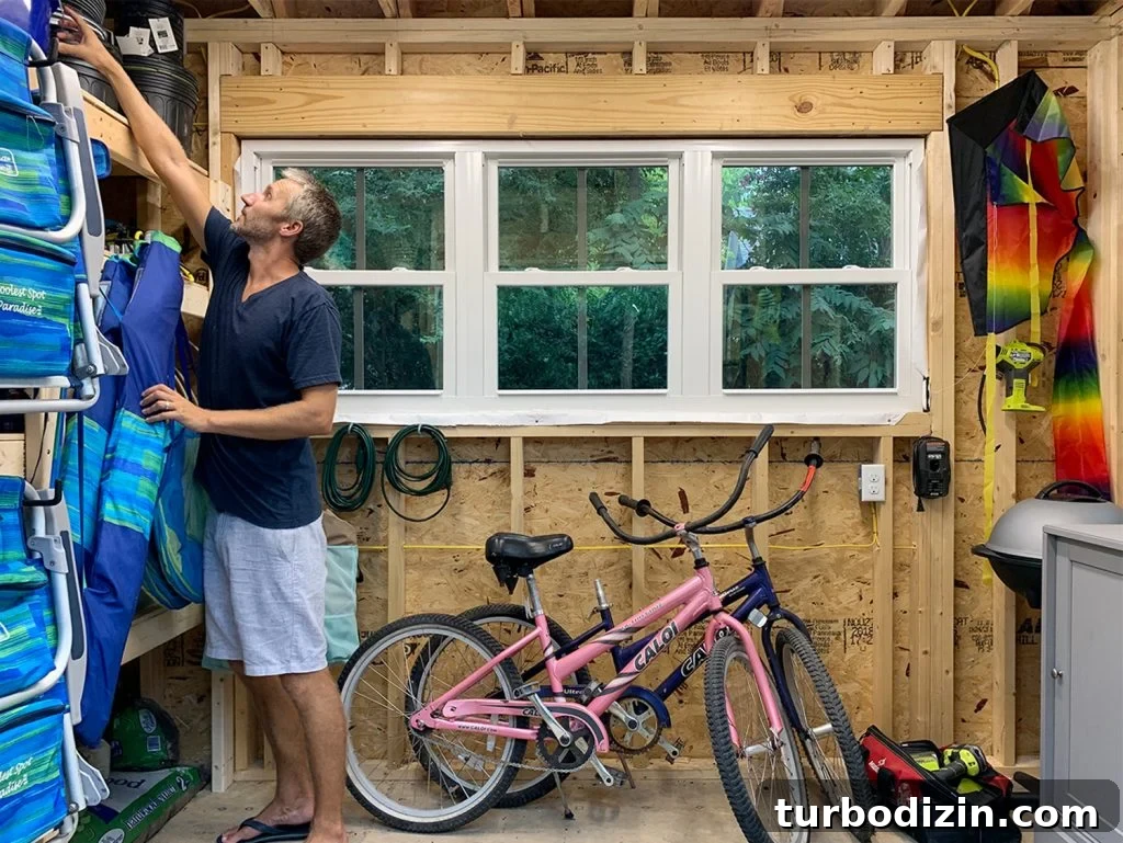 John reaching for something in beach house shed
