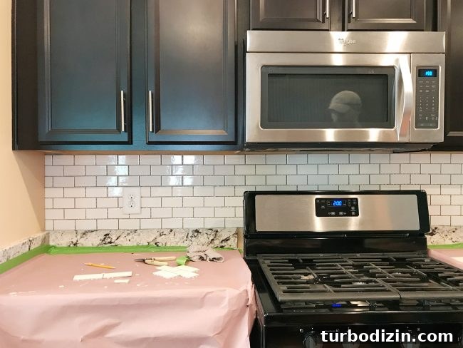 Install a Subway Tile Kitchen Backsplash for $200 DIY Guide 12 kitchen backsplash with subway tile hung but not grouted