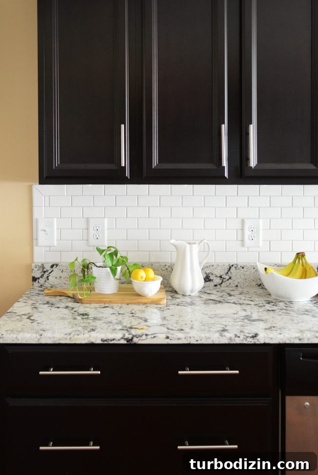 Install a Subway Tile Kitchen Backsplash for $200 DIY Guide 18 white subway tile sheet backsplash with black cabinetry